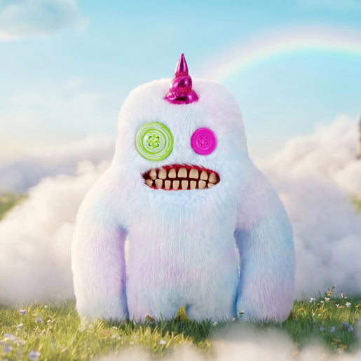 Fuggler Fugglercorns Sasquoosh plush toy with pastel ombre fluff, a metallic bright pink unicorn horn, mismatched green and pink button eyes, and a wide mouth full of human-like teeth.