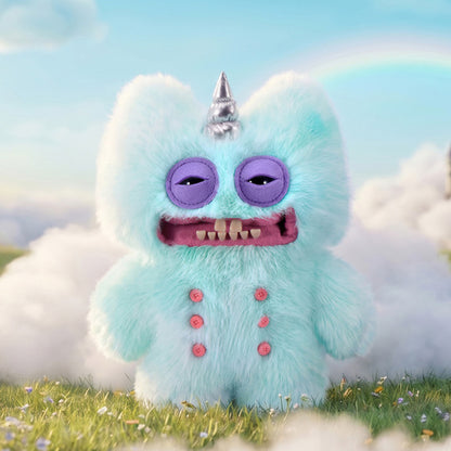 Fuggler Fugglercorns Stinkface plush toy with fluffy pastel blue fur, a shiny silver unicorn horn, purple sleepy eyes, human-like teeth, and four pink buttons on its belly.