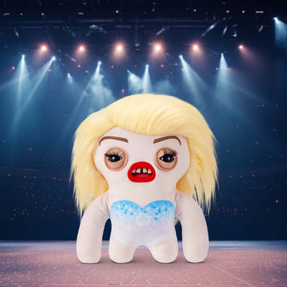 Fuggler Fuggstars Series 1 Fleeting Fartlet plush with a performing stage in the background