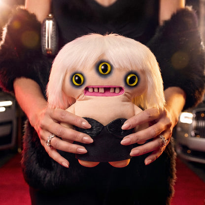 Fuggler Fuggstars Series 2 Lady Fugg plush wearing a black bustier with a platinum blonde bob haircut, three eyes, and human-like teeth.