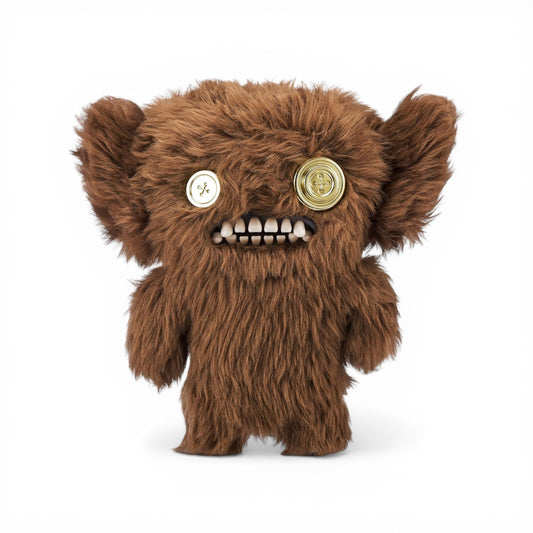 Brown long-haired Fuggler Gold Fuggs 9-inch plush Grumpy Grumps with two mismatched metallic gold button eyes and gold teeth.