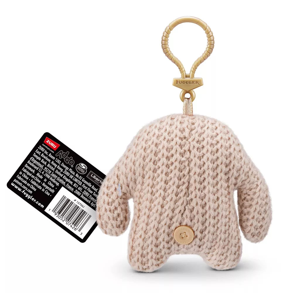 back of Shop the 5-inch Fuggler Series 5 Mr. Needles Cream keyring plush. A knitted cream monster featuring long arms, human-like teeth, and a backpack clip.