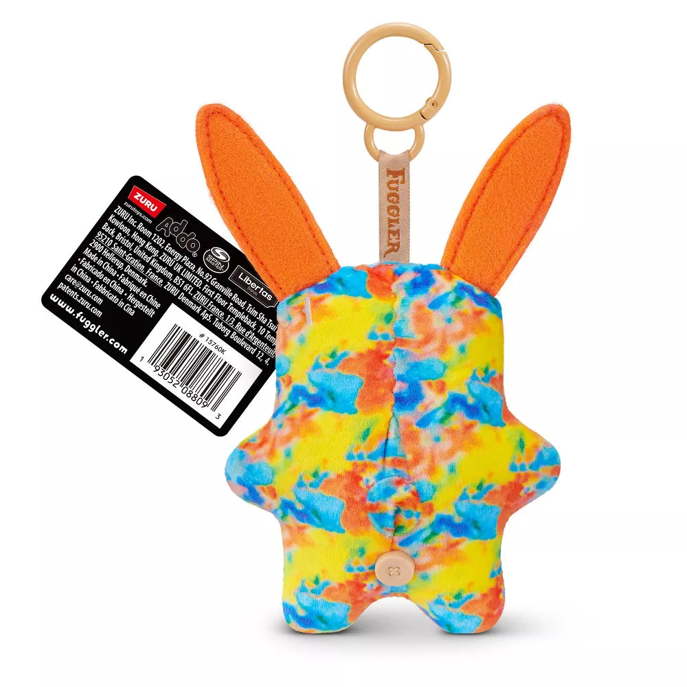 back view of Fuggler Series 6 Rabid Rabbit 5-inch keyring plush in Multi-Color variation, featuring tie-dye fleece fur, long orange ears, and two buck teeth.