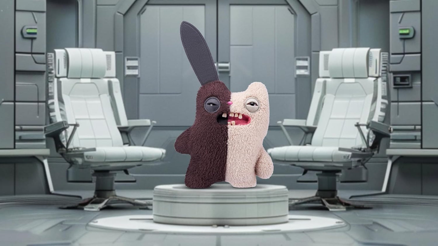Stuffed toy with a split face in a futuristic room with chairs and control panels.
