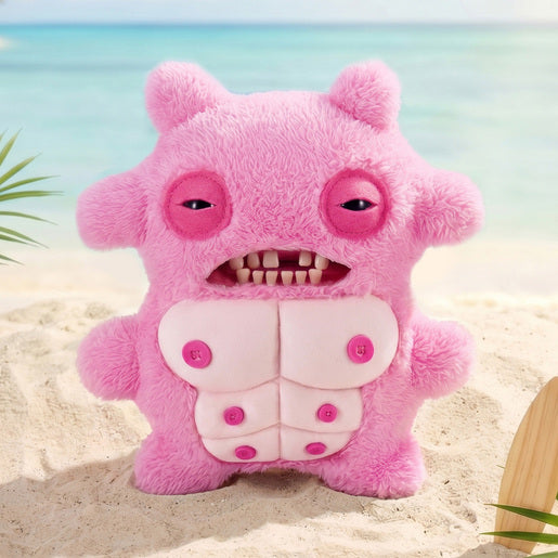 Fuggler Nipple Fuggs Sir Nobbynuts plush toy in fluffy bubblegum pink with human-like teeth, half-closed eyes, and six pink buttons on its belly on a sandy beach