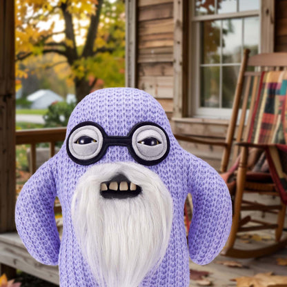 Fuggler Old Fogies Mr Needles with a white beard and black glasses on a wooden porch.
