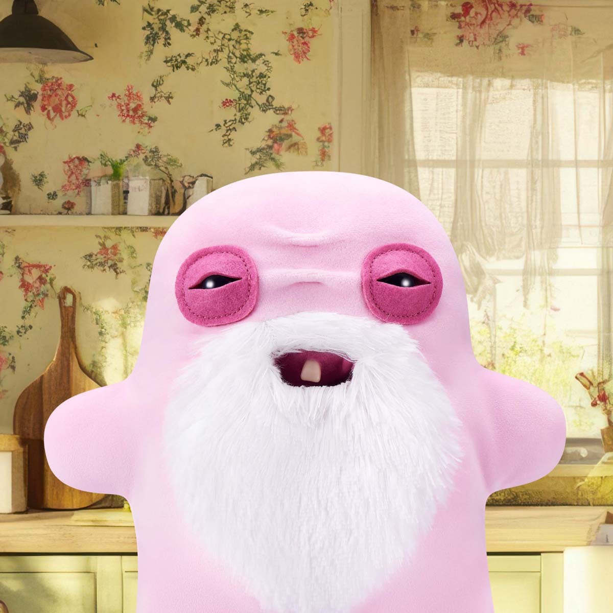 Fuggler Old Fogies Oogah Boogah plush in a room with floral wallpaper.