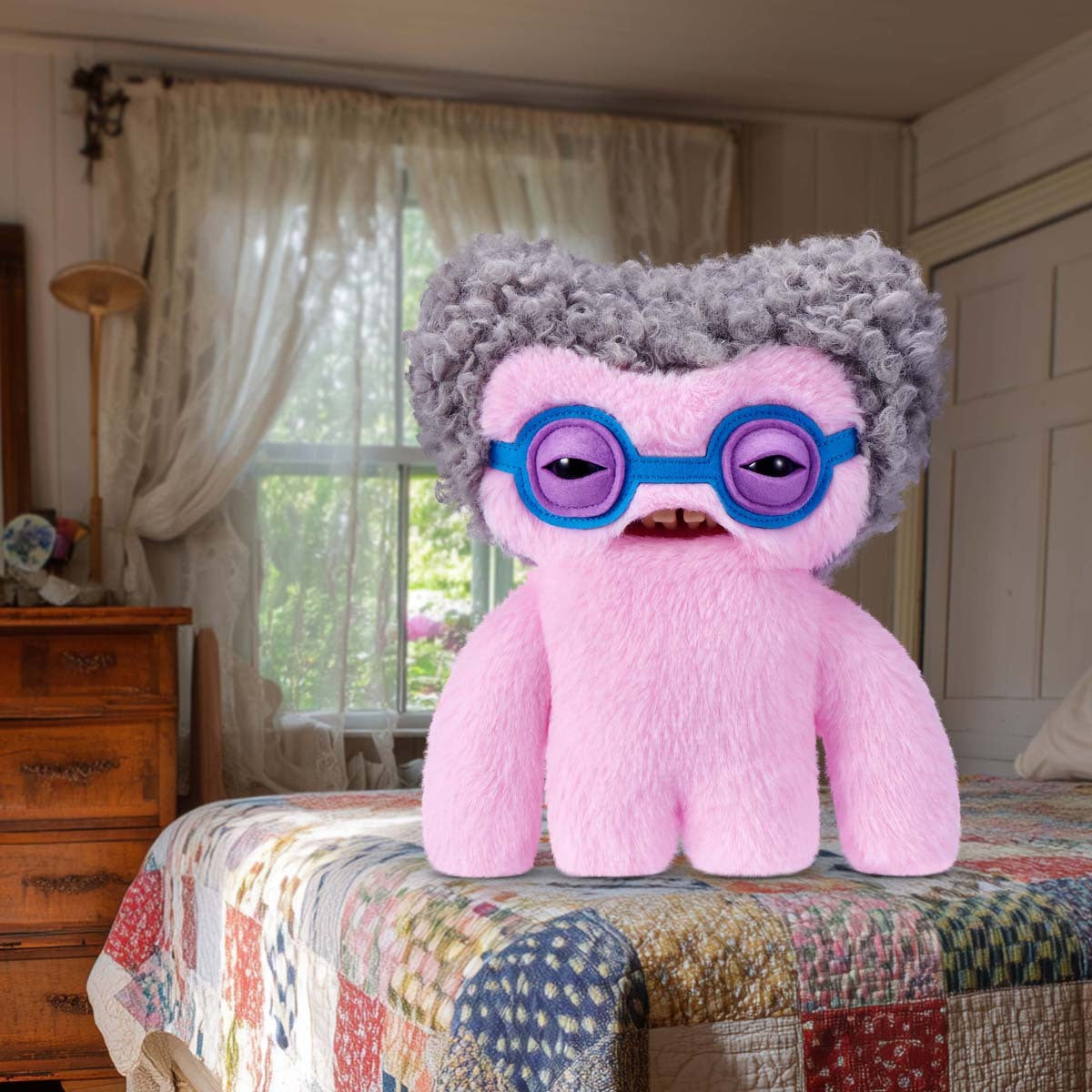 Fuggler Old Fogies Squidge plush with gray hair and purple glasses on a bed