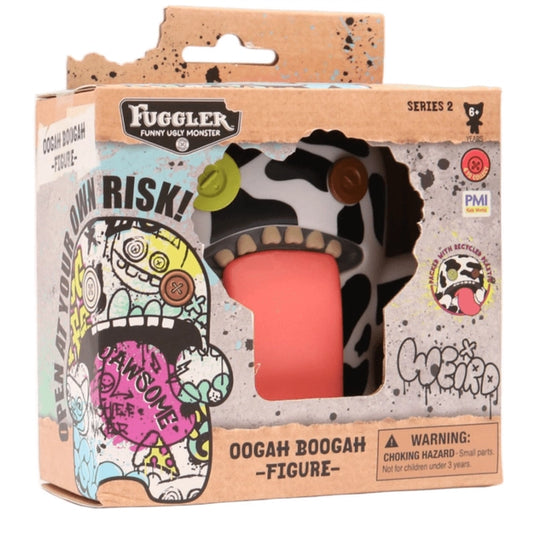 Fuggler Oogah Boogah 4.5-inch figure featuring a black and white cow print pattern, mismatched button eyes, and a giant tongue sticking out.