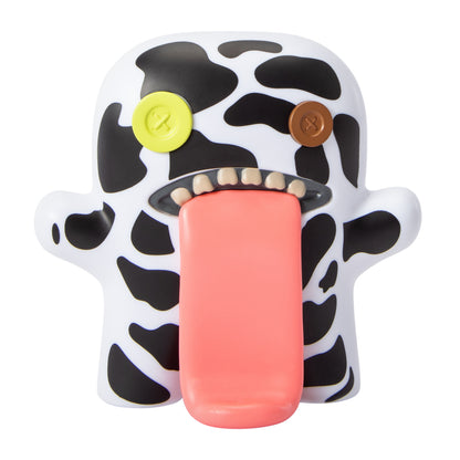 Fuggler Oogah Boogah 4.5-inch figure featuring a black and white cow print pattern, mismatched button eyes, and a giant tongue sticking out.