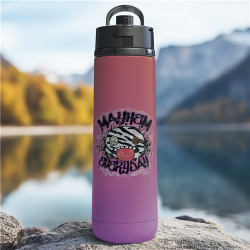 Purple water bottle with a zebra design and text on a rock by a lake with mountains in the background