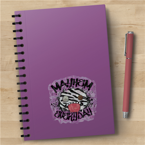 Purple notebook with a zebra design and text on a wooden surface with a pen next to it