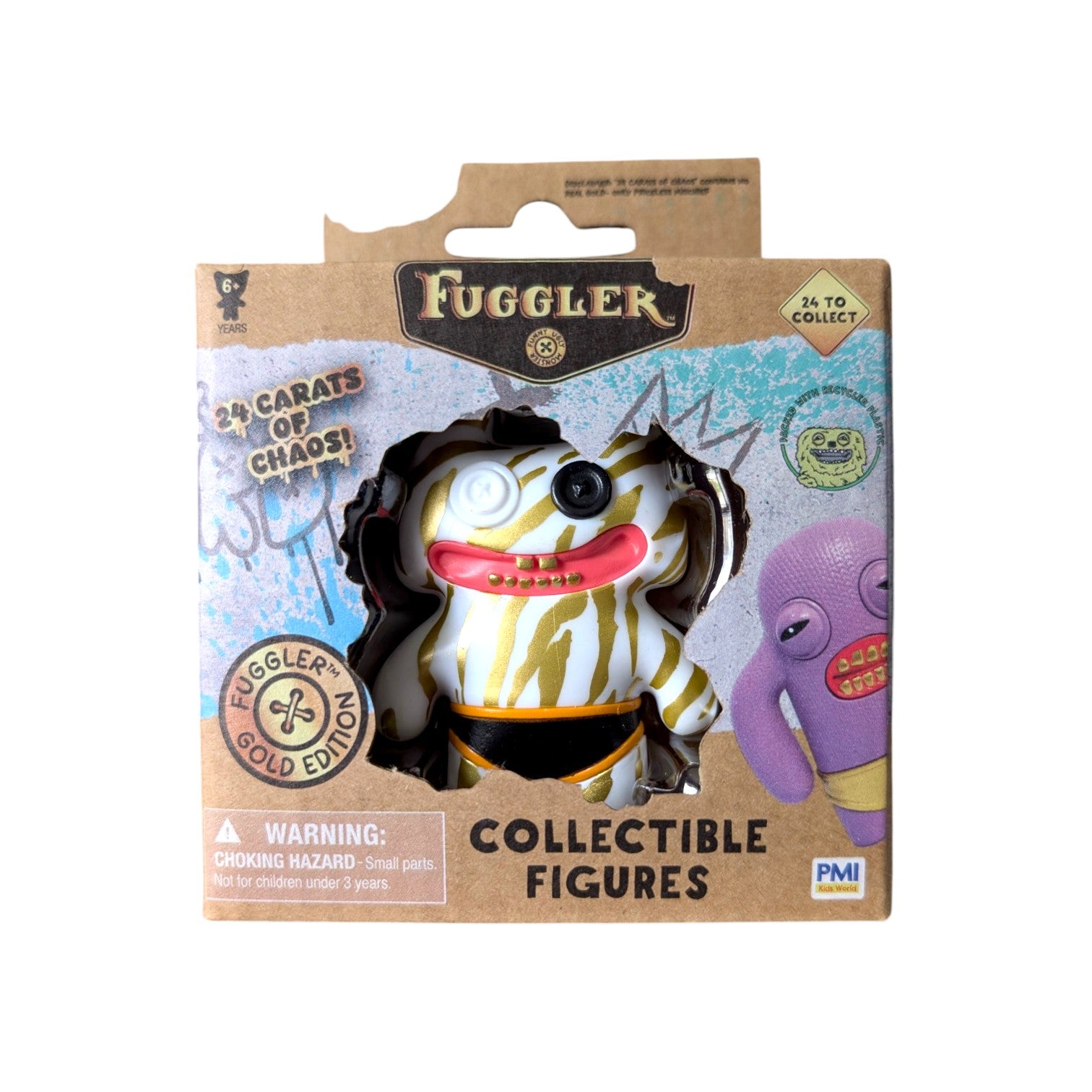 Fuggler Series 3 Gold Edition Stinkface Zebra vinyl figure featuring a white body with gold stripes, mismatched button eyes, and black underwear in a 24 Carats of Chaos window box.
