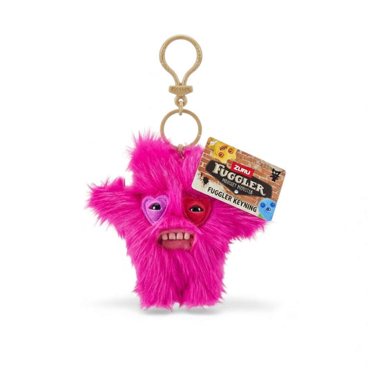A product photo of the Fuggler Series 5 Captain Cardiac Keyring, a 5-inch pink fuzzy heart-shaped plush clip with mismatched heart eye patches and human-like teeth.