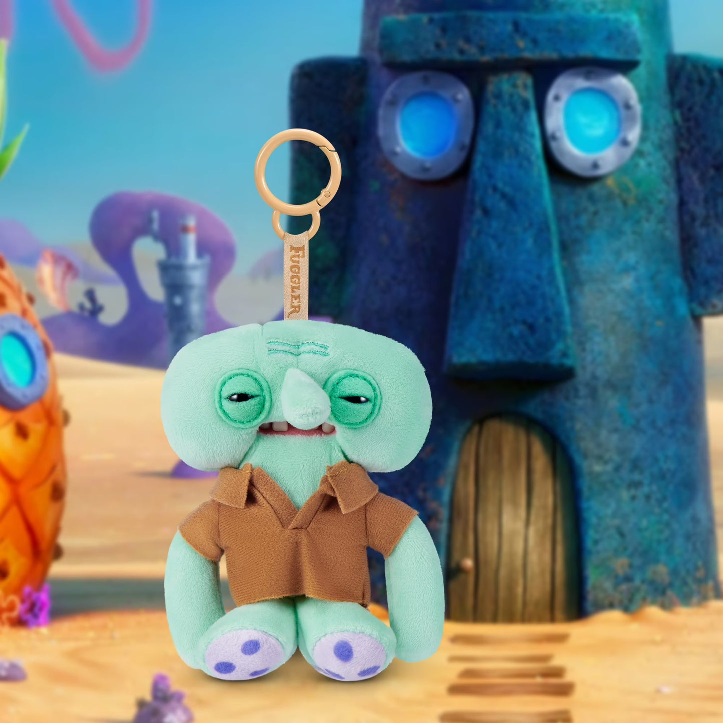 Plush toy resembling a character from a cartoon with a pineapple and robot-like figure in the background.