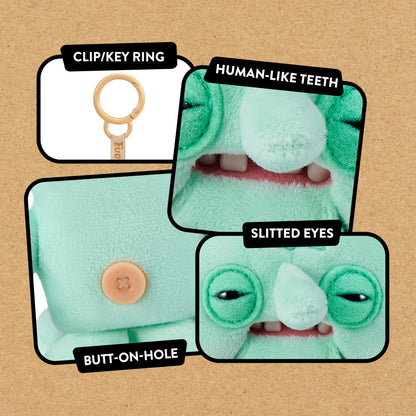 Green plush toy with text labels on a brown background