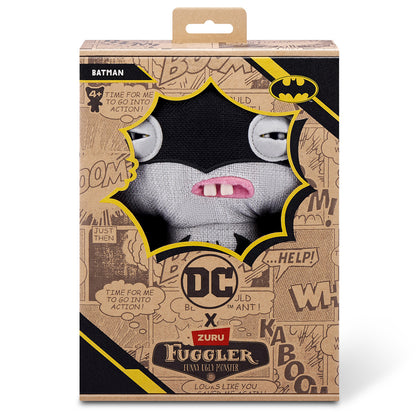 The Fuggler x DC Batman plush inside its collector box, featuring comic book style graphics, the "Batman" name tag, and the Bat-Signal logo.