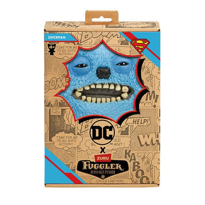The Fuggler x DC Superman plush inside its collector box, featuring comic book style graphics, the "Superman" name tag, and the Superman Shield logo.