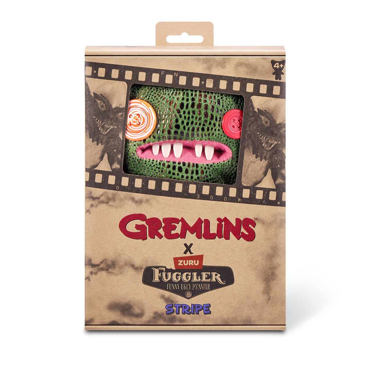 Product packaging for the Fuggler x Gremlins Stripe plush, featuring a green scaly monster with a white mohawk and human-like teeth looking out of a movie-reel box.