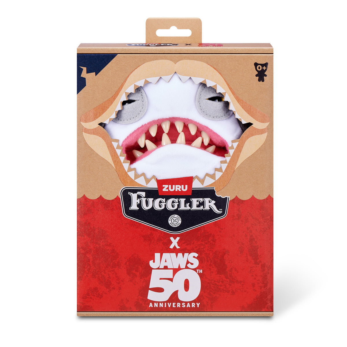 The Fuggler x Jaws plush inside its 50th Anniversary collector box, featuring the classic Jaws logo and a "bite" cutout revealing the monster's face.