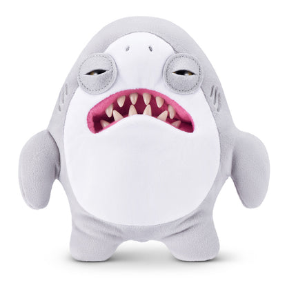 A product shot of the Fuggler x Jaws 9-Inch plush toy, a grey shark with wild eyes and a mouth full of human-like teeth instead of shark teeth.