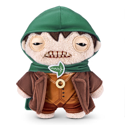 A product shot of the Fuggler x Lord of the Rings Frodo Baggins 9-Inch plush toy, wearing a green hooded Elven cloak and the One Ring necklace.