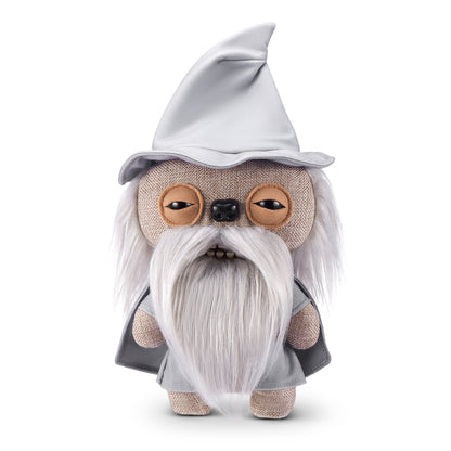 A product shot of the Fuggler x Lord of the Rings Gandalf 9-Inch plush toy, featuring a grey wizard hat, a long white fuzzy beard, and a mouth with human-like teeth.