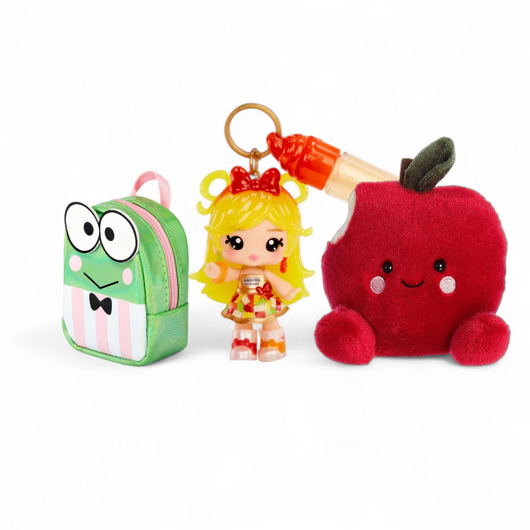 Set of three plush keychains: a green backpack, a girl with blonde hair, and a red apple with a smiley face on a white background.