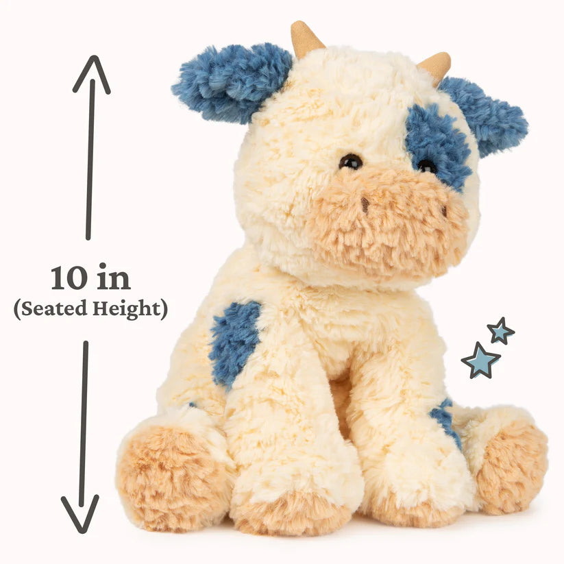 Stuffed animal cow with blue spots and measurement text on a white background