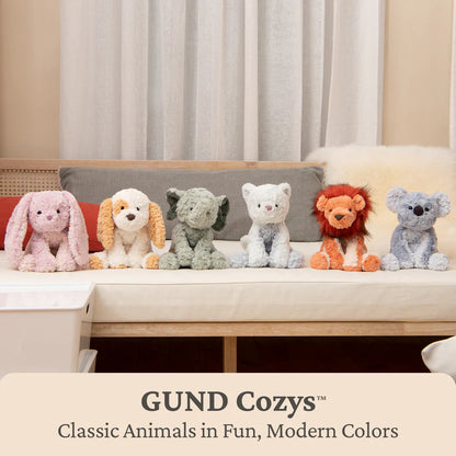 GUND Cozys plush toys on a couch with a neutral background