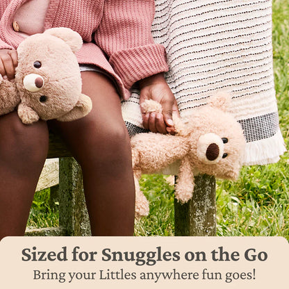Two children holding teddy bears in a grassy area with promotional text about teddy bears being 'Sized for Snuggles on the Go'.