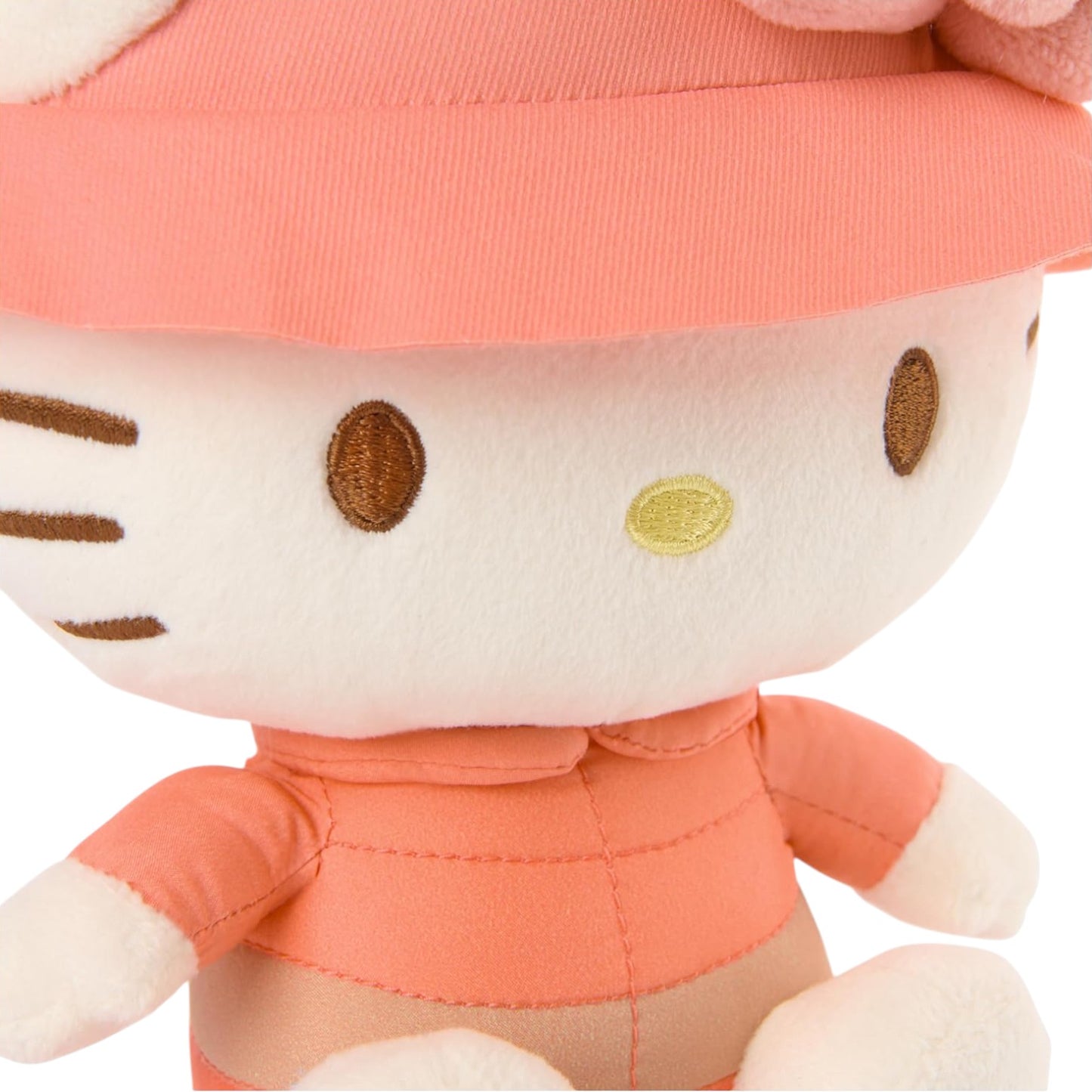 Plush toy resembling a character with a pink outfit on a white background
