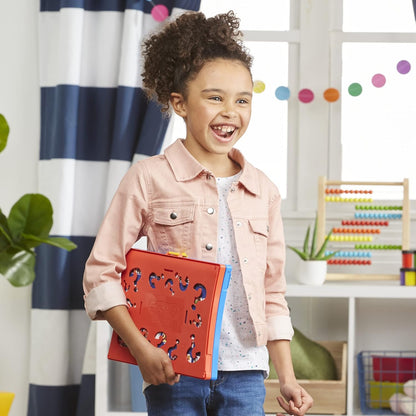 Child holding a red folder with question marks in a classroom setting