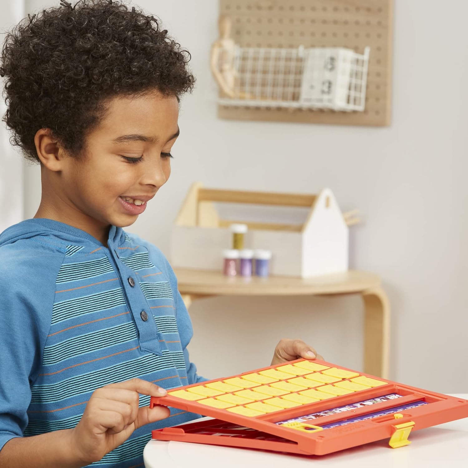 Child playing with a toy educational tool in a home setting