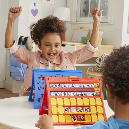 Child with arms raised in excitement at a table with educational toys