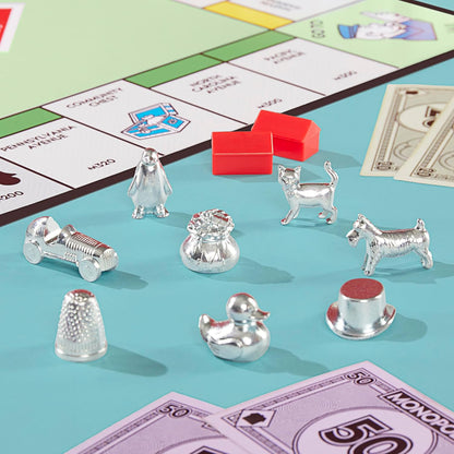 Close-up of Monopoly game pieces and money on a board with property cards.