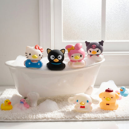 Hello Kitty and Friends Duckz figures lined up on a wooden bath tray, featuring Hello Kitty, My Melody, Kuromi, Cinnamoroll, Chococat, and Pompompurin.