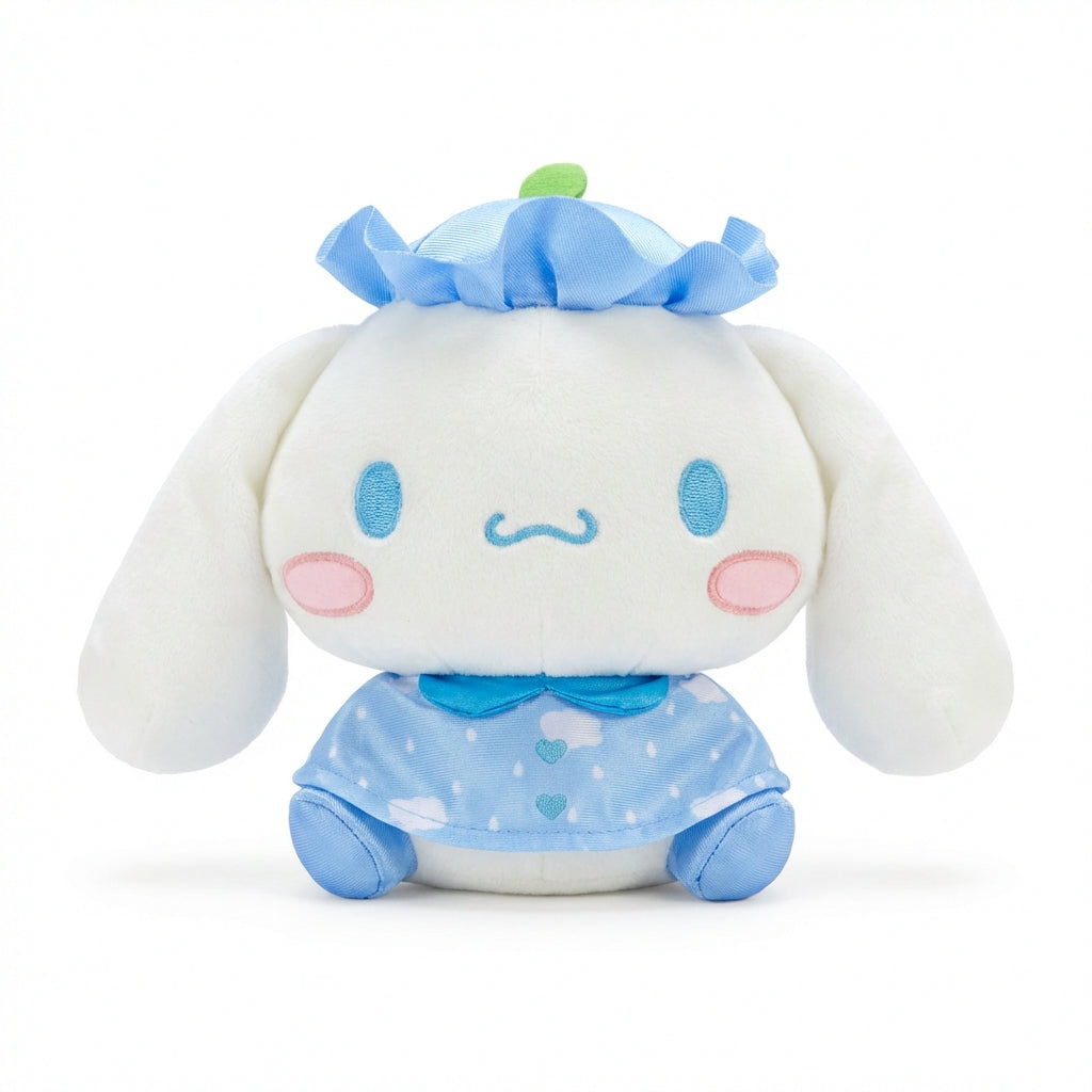 Hello Kitty and Friends plush featuring Cinnamoroll wearing a blue ruffled hat with a green leaf and a matching sky-blue cape with cloud patterns and heart buttons.