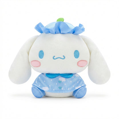 Hello Kitty and Friends plush featuring Cinnamoroll wearing a blue ruffled hat with a green leaf and a matching sky-blue cape with cloud patterns and heart buttons.