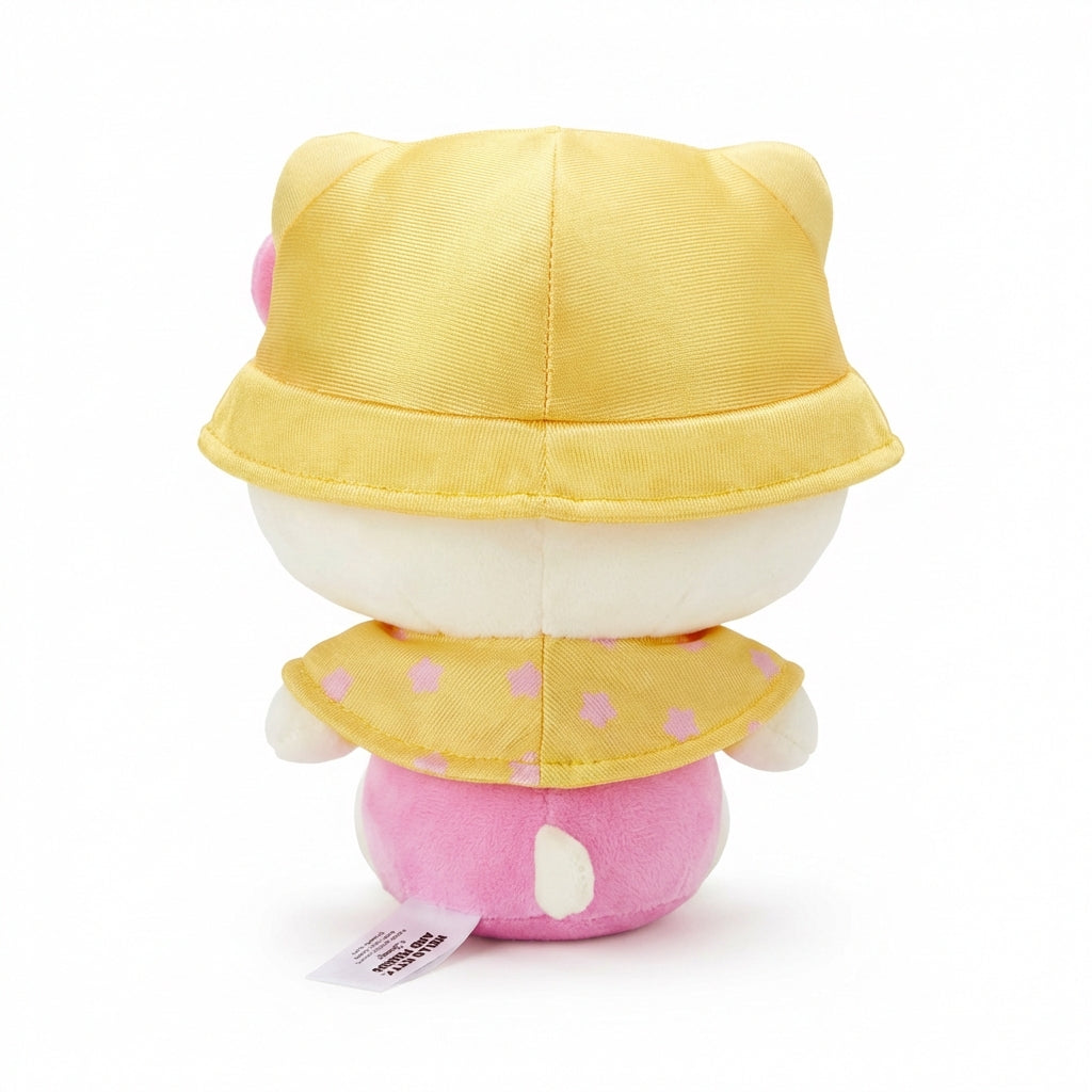 Hello Kitty and Friends plush featuring Hello Kitty wearing a yellow bucket hat and cape with pink flowers and bee details, along with her signature pink bow.