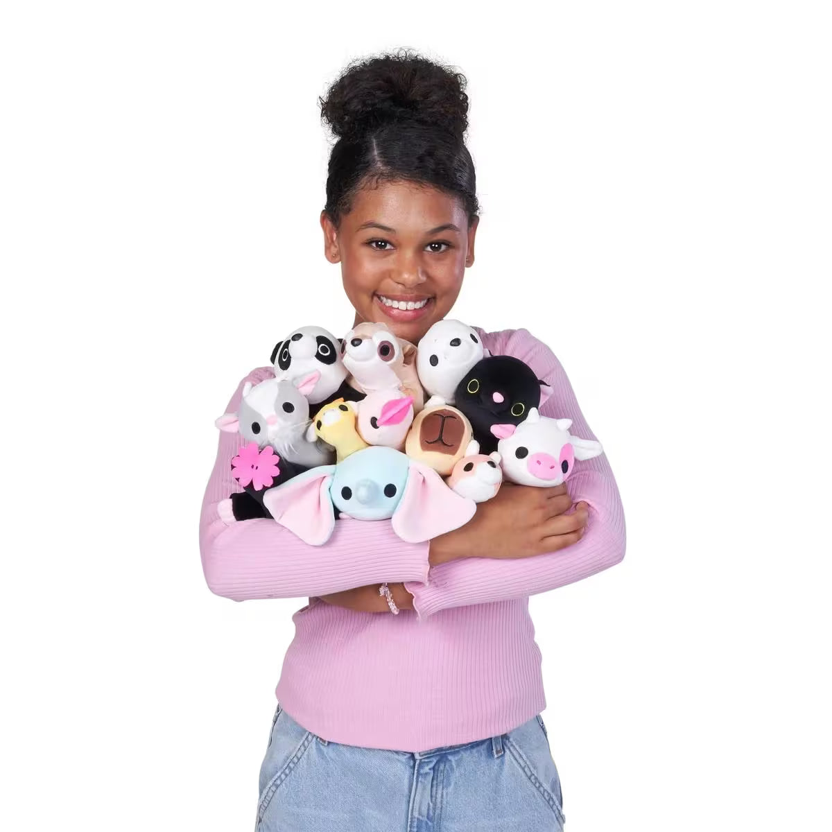 Person holding a collection of baby-size weighted plush toy by ZURU 