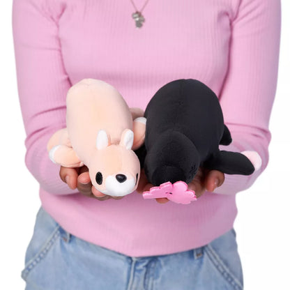 Person holding Jess the Kangaroo baby-size weighted plush toy by ZURU featuring a soft peach-colored body and white facial accents.