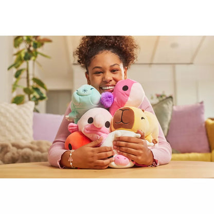 Person holding Small Hug-A-Lumps Series 2 weighted plush toy by ZURU in a cozy indoor setting