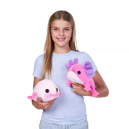 Young girl holding Small Hug-A-Lumps Series 2 Blob Fish weighted plush toy by ZURU featuring a bright pink face and super-soft fabric.