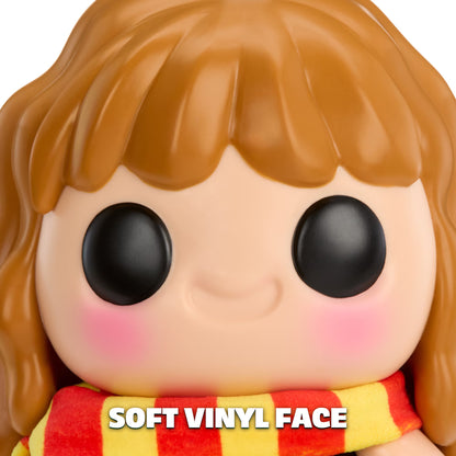 Close-up of a stylized vinyl figure face with large black eyes, peach skin, brown hair, pink cheeks, and a red-and-yellow striped scarf. White text at the bottom reads 'SOFT VINYL FACE'.