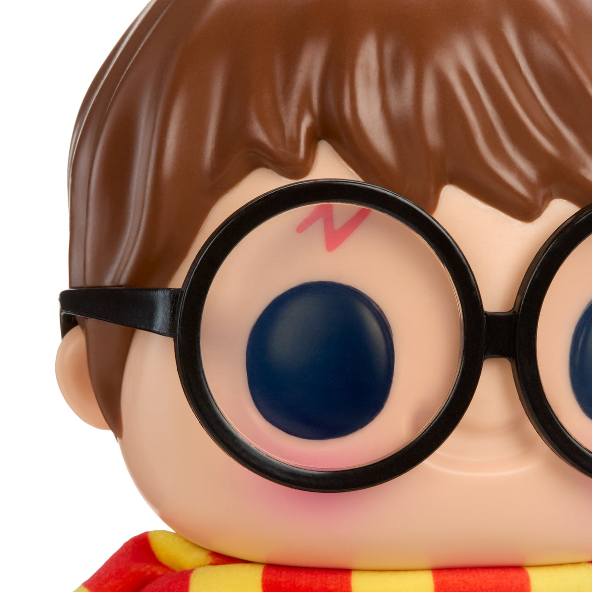 Close-up of a stylized collectible figure with brown hair, large round black glasses, a pale peach face, and a red-and-yellow striped scarf on a white background.