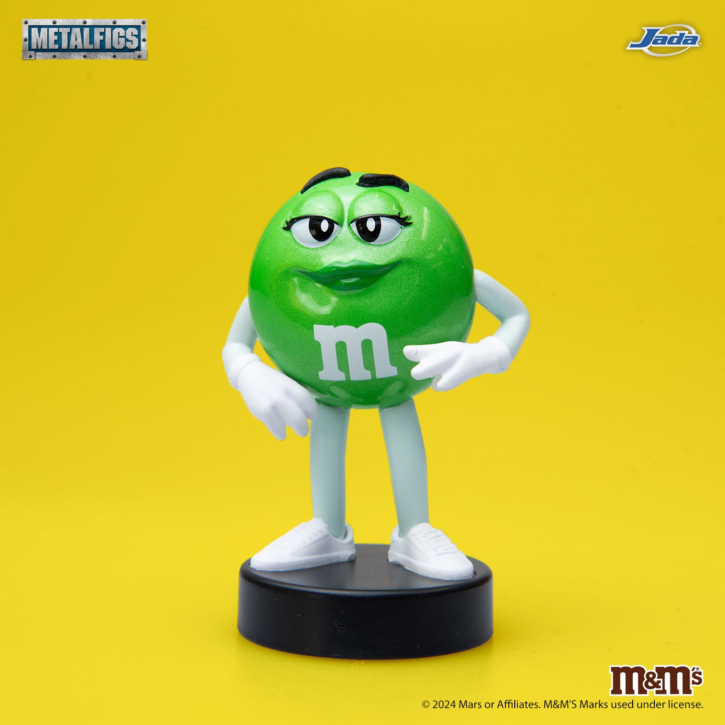 Jada Toys M&M's Green Character 2.5-inch Metalfigs die-cast figure mounted on a black display pedestal.