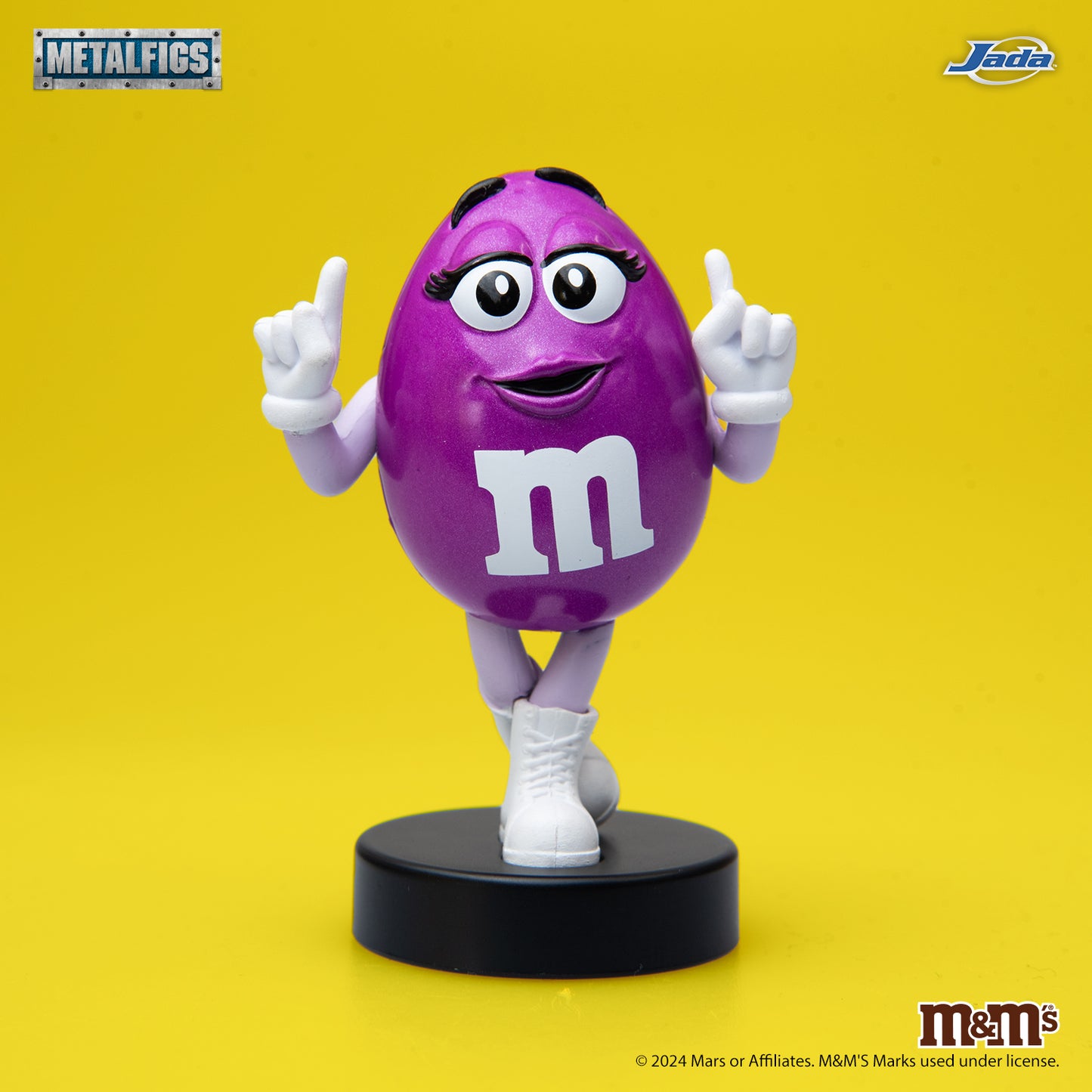 Jada Toys M&M's Purple Character 2.5-inch Metalfigs die-cast figure mounted on a black display pedestal.