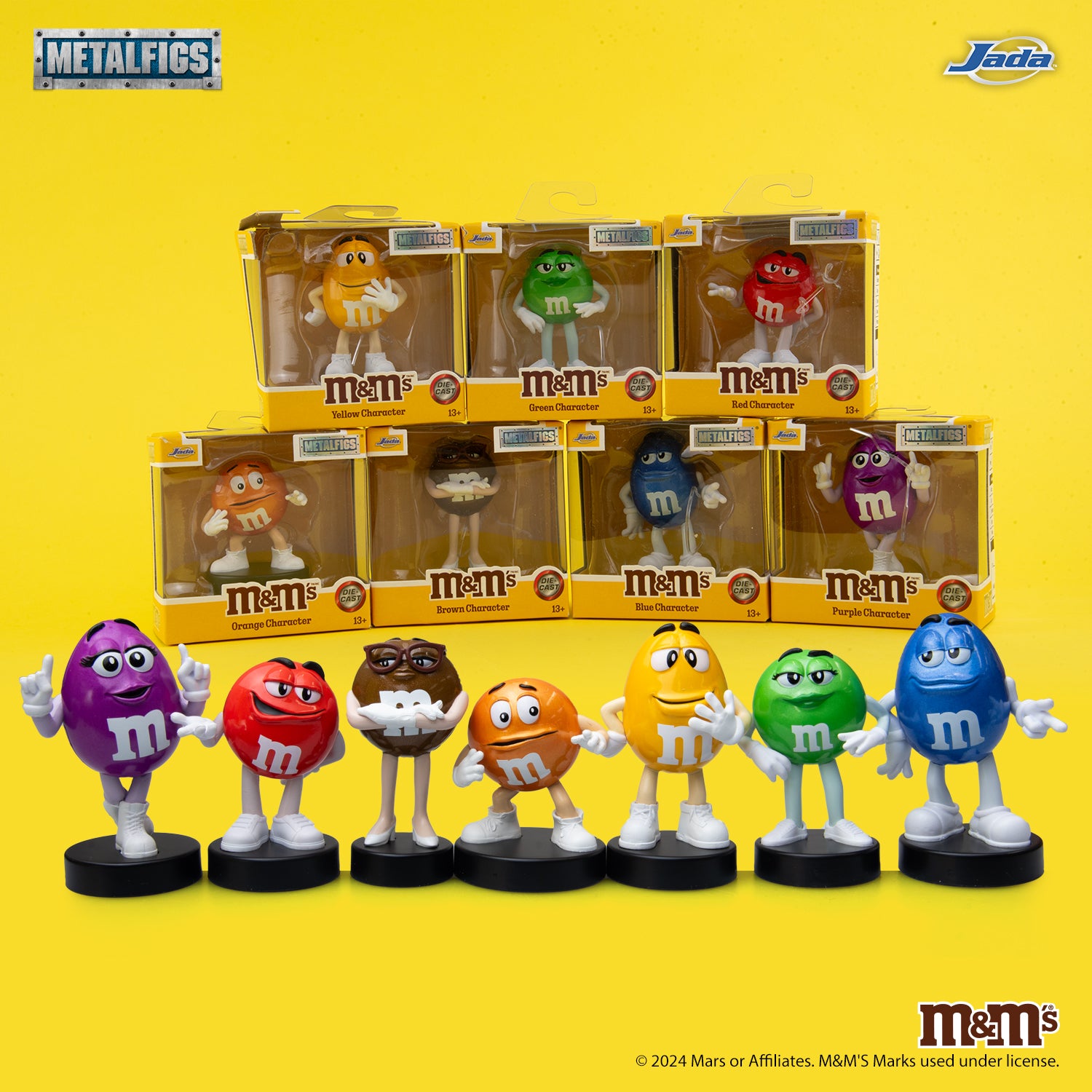 Jada Toys M&M's Red Character 2.5-inch die-cast metal figure standing confidently with hands on hips on a black pedestal.