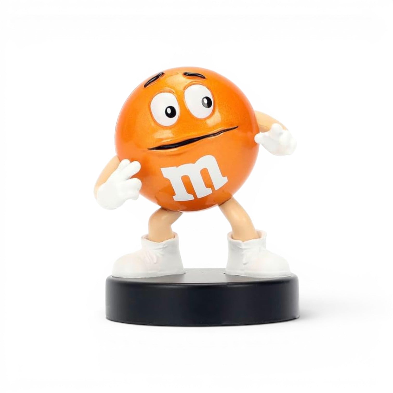 Jada Toys M&M's Orange Character 2.5-inch die-cast metal figure standing with a nervous expression and hands on his face on a black pedestal.